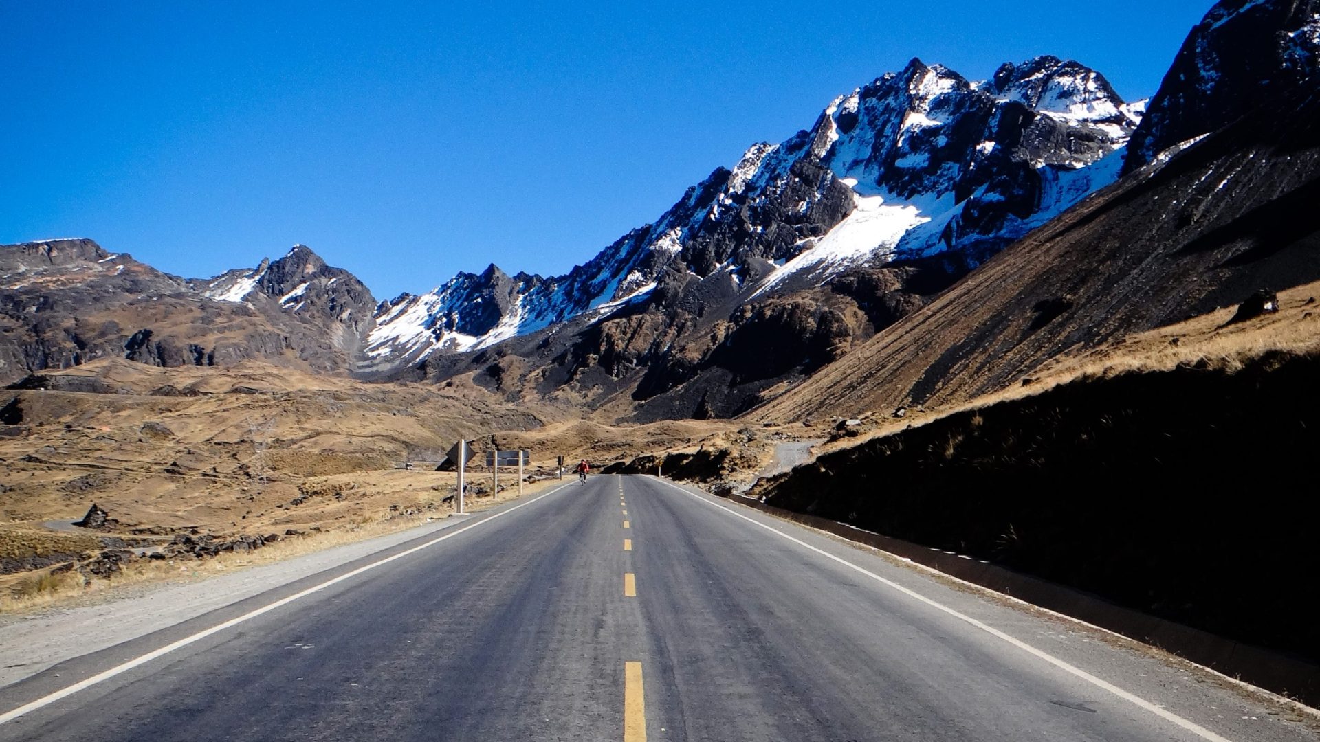 Route asphaltée de l'Altiplano menant aux sommets enneigés des Andes au départ de la descente VTT, La Paz, Bolivie