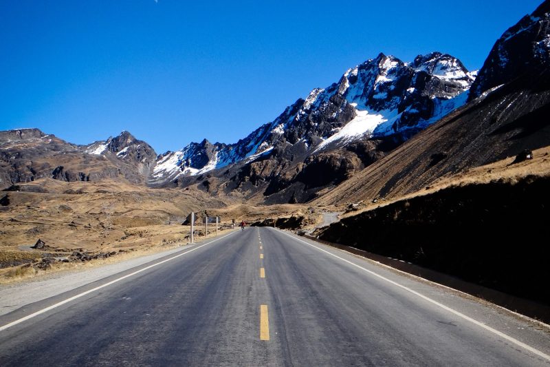 Route asphaltée de l'Altiplano menant aux sommets enneigés des Andes au départ de la descente VTT, La Paz, Bolivie